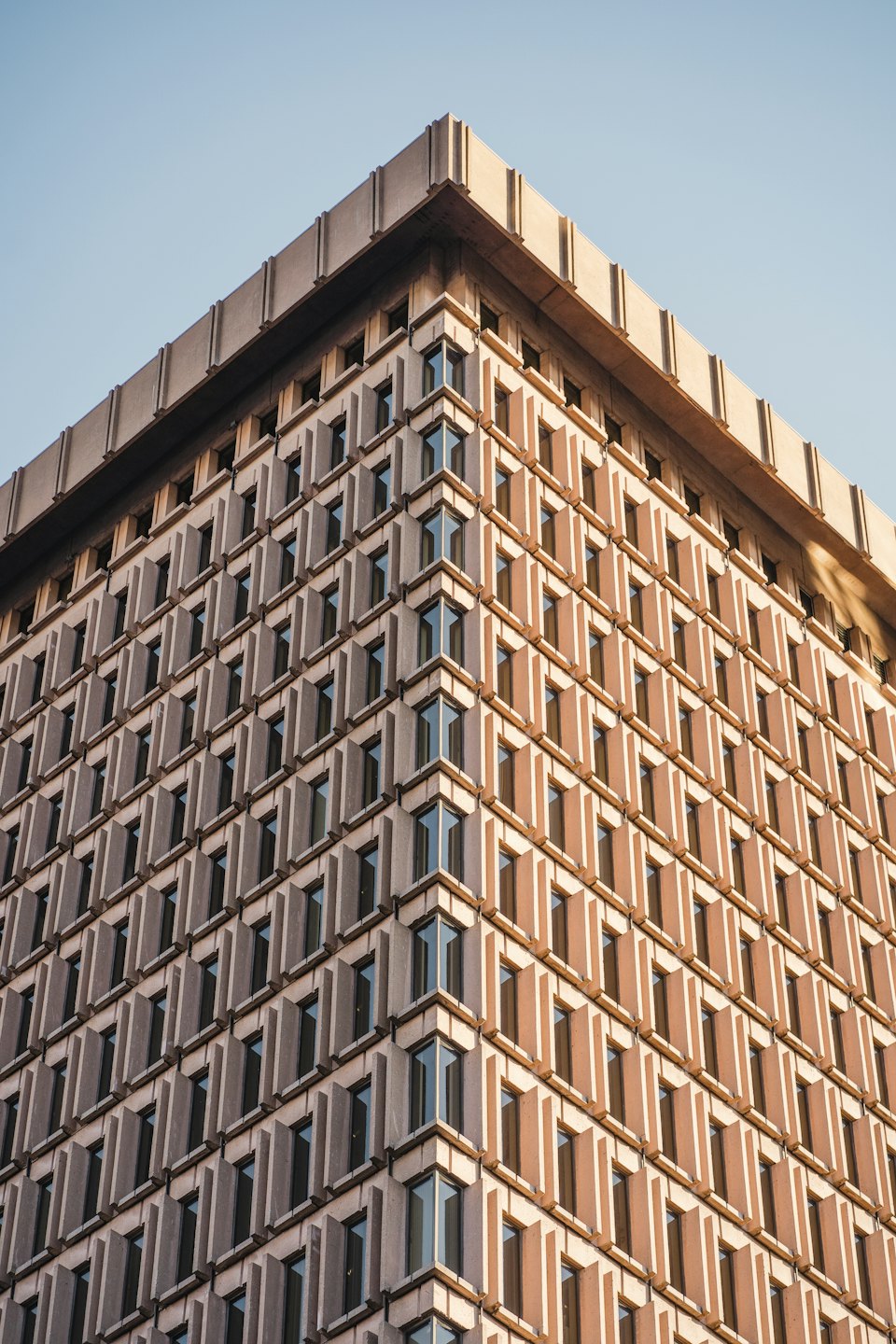 Modern Brutalist office building with geometric concrete facade.